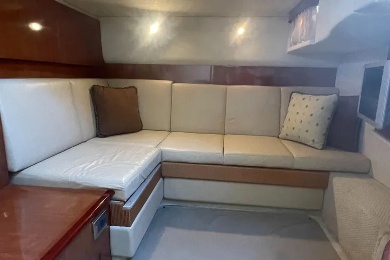Slide: The Image of Interior of 2006 Sea Ray 380 Sundancer with beige seating and cushions. - 6