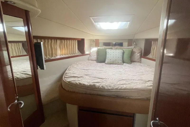 Slide: The Image of 2006 Sea Ray 380 Sundancer cabin with cozy bed and elegant decor. - 9