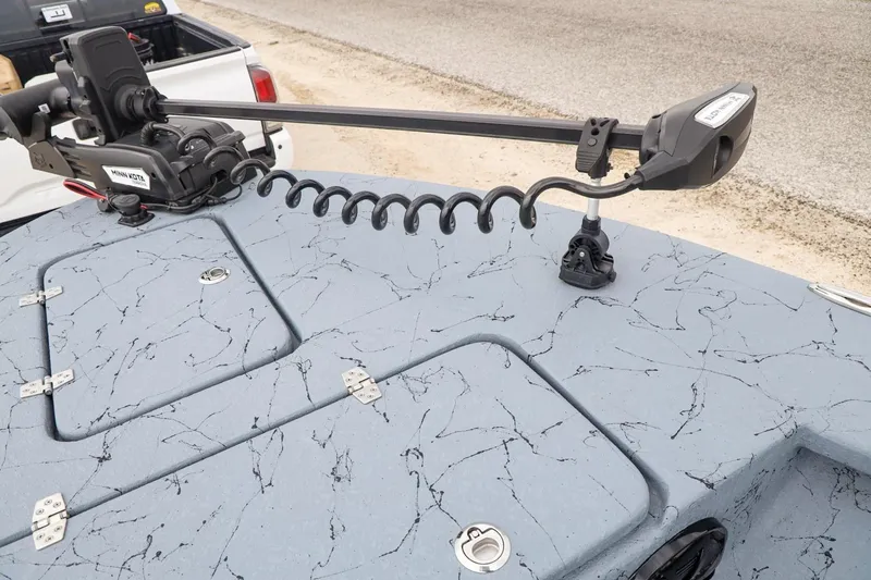 Slide: The Image of 2025 Haynie 24 High Output boat with Minn Kota trolling motor on textured deck. - 12