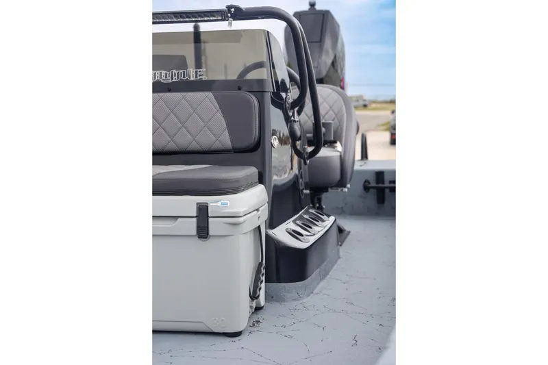 Slide: The Image of 2025 Haynie 24 High Output boat interior with seating and cooler. - 16
