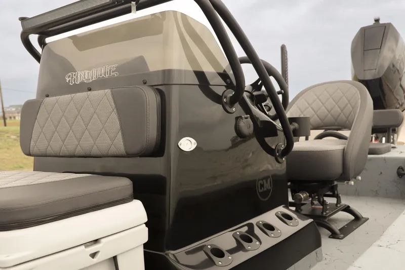 Slide: The Image of 2025 Haynie 24 High Output boat interior with gray seating and console details. - 17
