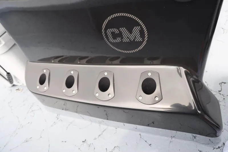 Slide: The Image of 2025 Haynie 24 High Output boat detail with sleek black finish and four exhaust ports. - 20