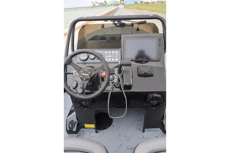 Slide: The Image of 2025 Haynie 24 High Output boat dashboard with steering wheel and navigation system. - 25