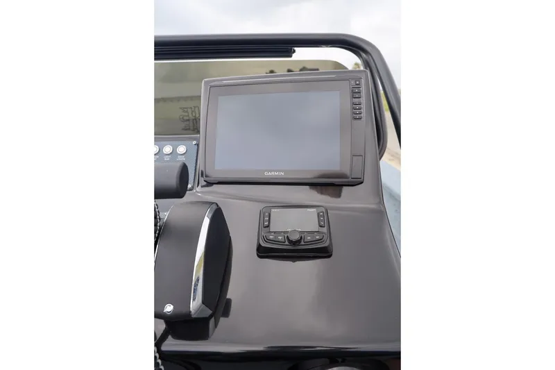 Slide: The Image of 2025 Haynie 24 High Output boat dashboard with Garmin navigation system. - 27