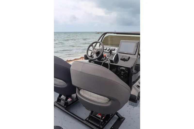 Slide: The Image of 2025 Haynie 24 High Output boat interior with steering wheel and navigation system. - 28