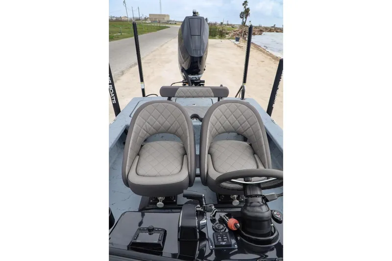 Slide: The Image of 2025 Haynie 24 High Output boat interior with dual seats and steering console. - 29