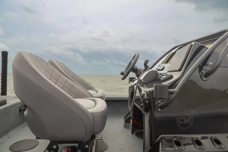 Slide: The Image of Interior of 2025 Haynie 24 High Output boat with steering console and seats. - 32