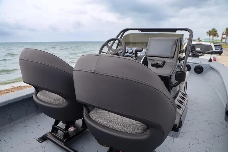Slide: The Image of 2025 Haynie 24 High Output boat interior with dual seats and navigation system. - 33