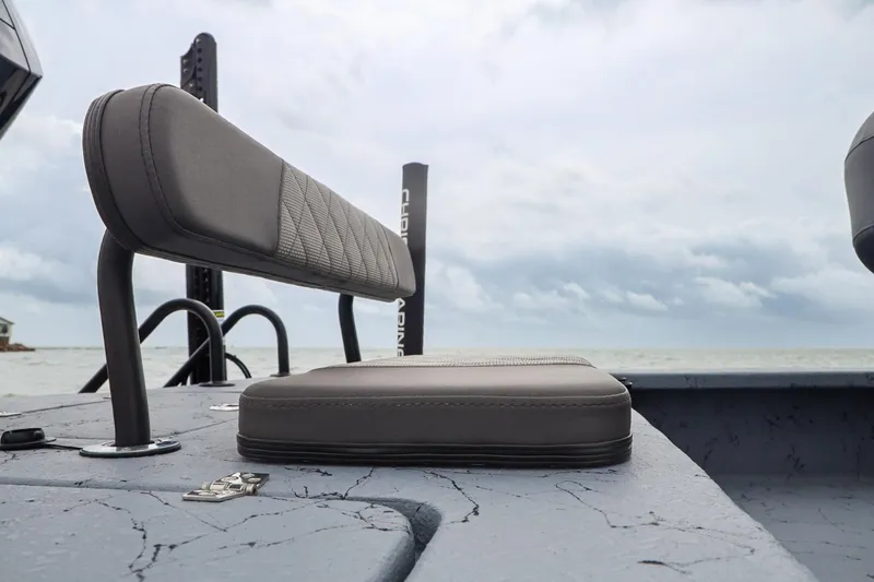 Slide: The Image of 2025 Haynie 24 High Output boat seat with ocean backdrop under cloudy sky. - 35