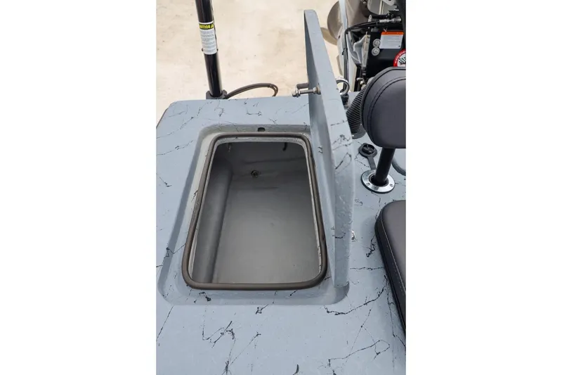 Slide: The Image of Open storage compartment on 2025 Haynie 24 High Output boat, featuring a sleek gray design. - 41