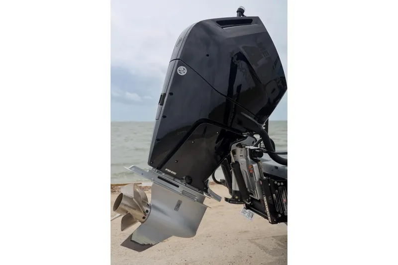 Slide: The Image of 2025 Haynie 24 High Output boat motor by the sea, showcasing sleek design and power. - 47