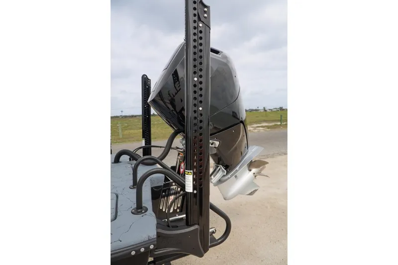 Slide: The Image of 2025 Haynie 24 High Output boat motor and power pole on a trailer. - 50