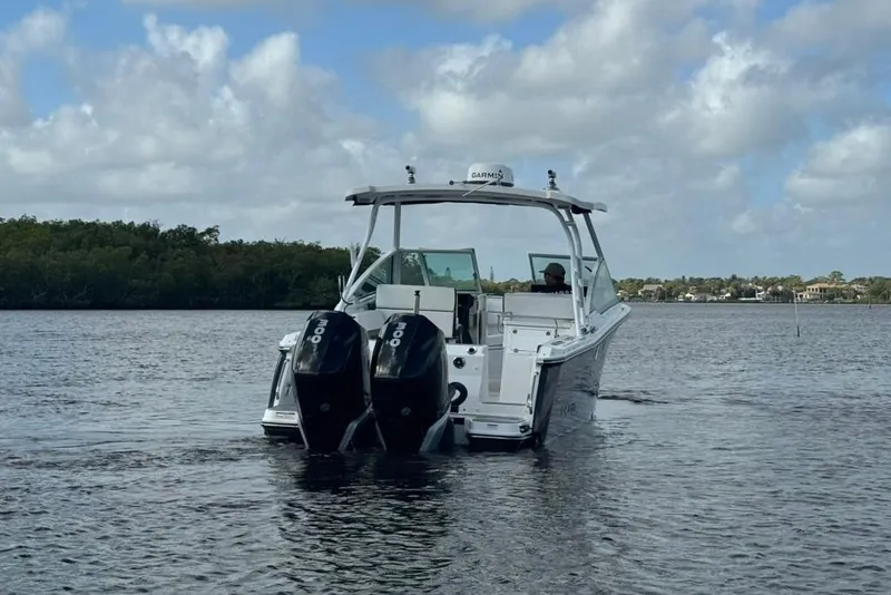 Slide: The Image of 2023 Blackfin 272 DC boat with dual engines on a calm waterway. - 13