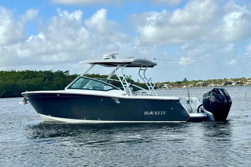 Slide: The Image of 2023 Blackfin 272 DC boat on calm water under a partly cloudy sky. - 17