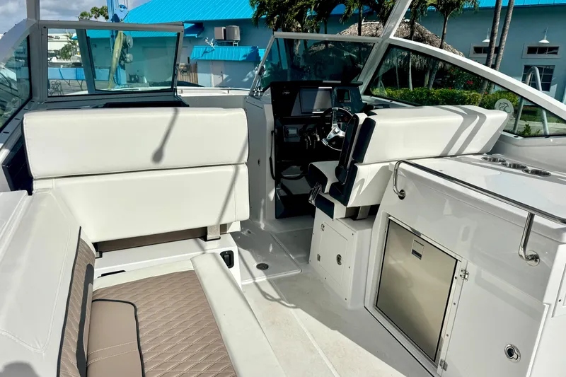Slide: The Image of 2023 Blackfin 272 DC boat interior with white seating and modern dashboard. - 21