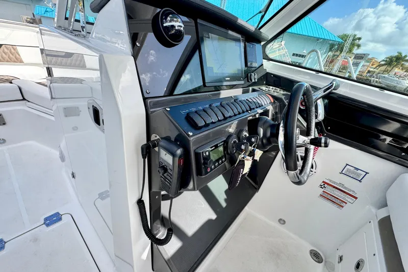 Slide: The Image of 2023 Blackfin 272 DC boat cockpit with modern controls and navigation system. - 26