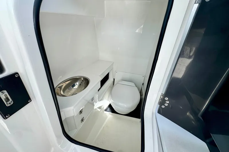 Slide: The Image of 2023 Blackfin 272 DC boat interior with compact bathroom and stainless steel sink. - 27
