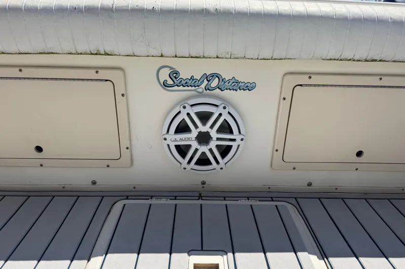 Slide: The Image of 2002 Parker 2510 Walkaround boat with JL Audio speaker and "Social Distance" text. - 12