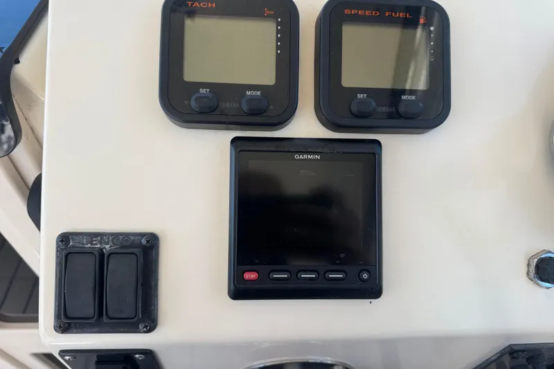 Slide: The Image of Control panel of a 2002 Parker 2510 Walkaround boat with Garmin and Yamaha displays. - 4