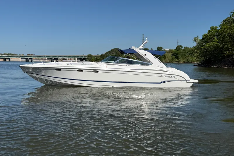 The Image of 2007 Formula 400 Super Sport boat cruising on a calm river under clear blue skies. - 0