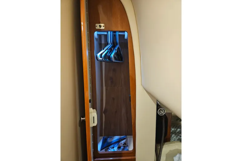 Slide: The Image of 2007 Formula 400 Super Sport yacht interior closet with hangers and wooden finish. - 12