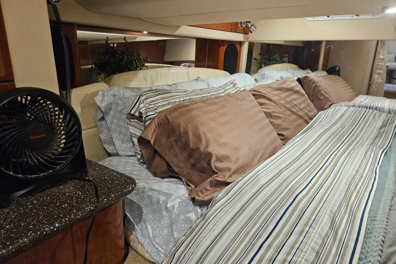 Slide: The Image of Interior of 2007 Formula 400 Super Sport boat with cozy bedding and fan. - 13