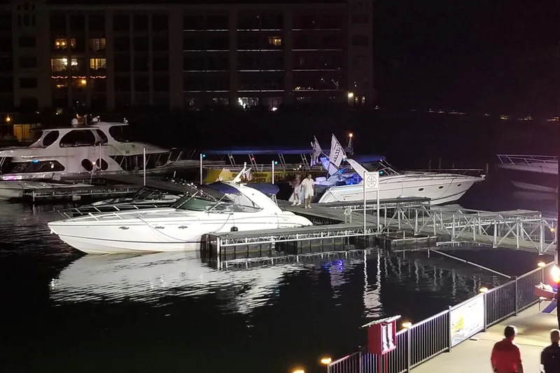 Slide: The Image of 2007 Formula 400 Super Sport yacht docked at night with other boats nearby. - 19