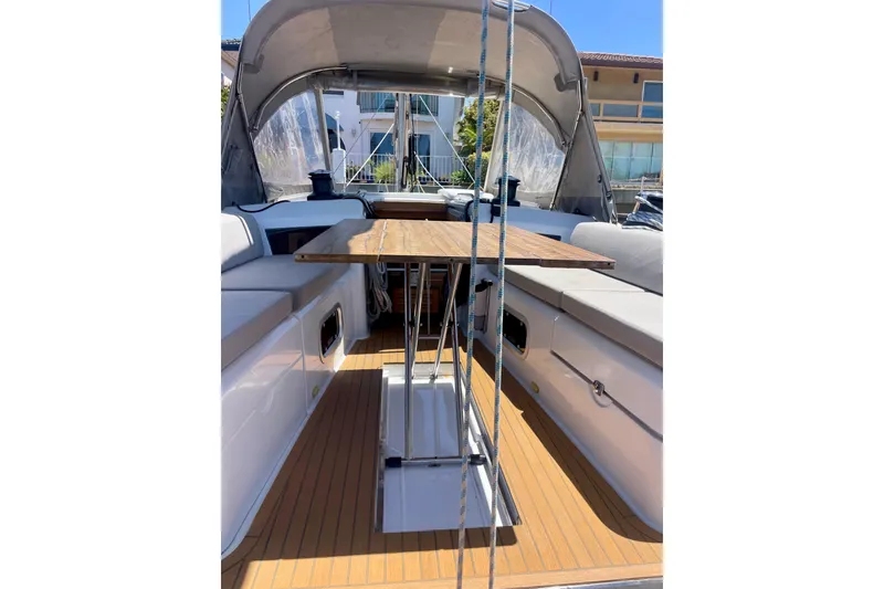 Slide: The Image of 2014 Grand Soleil 43F yacht cockpit with wooden table and seating area. - 10