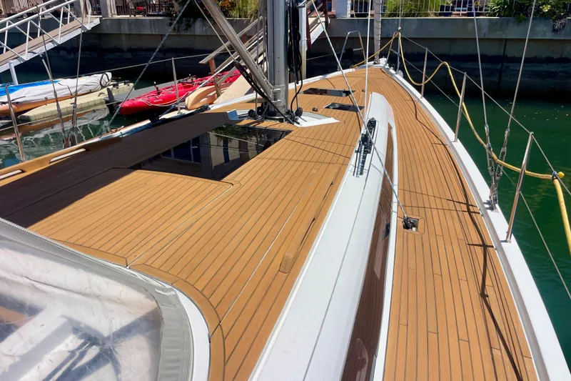Slide: The Image of 2014 Grand Soleil 43F sailboat deck with teak finish, docked in a marina. - 11