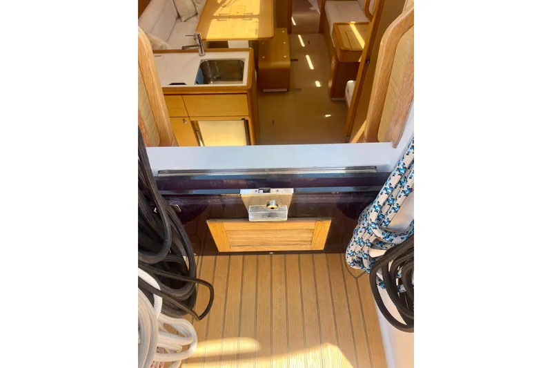 Slide: The Image of Interior view of 2014 Grand Soleil 43F yacht, featuring wooden cabinetry and nautical ropes. - 17