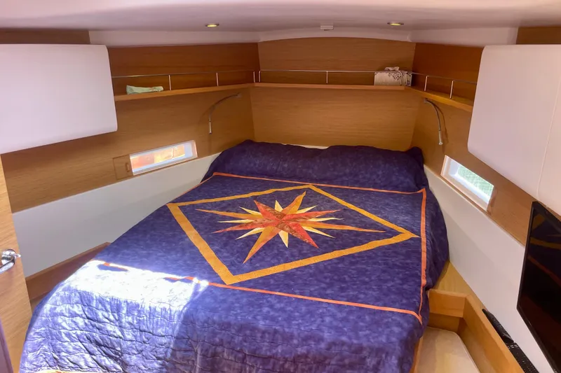 Slide: The Image of Cozy cabin interior of 2014 Grand Soleil 43F yacht with nautical-themed bedding. - 20