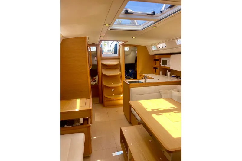 Slide: The Image of Interior of 2014 Grand Soleil 43F yacht, featuring modern wood finish and skylight. - 22