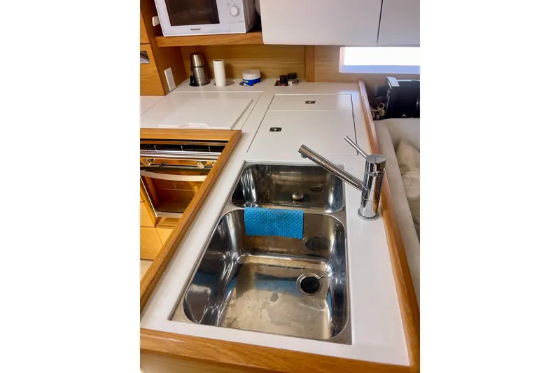 Slide: The Image of Modern kitchen sink in 2014 Grand Soleil 43F yacht, featuring stainless steel and wooden accents. - 28
