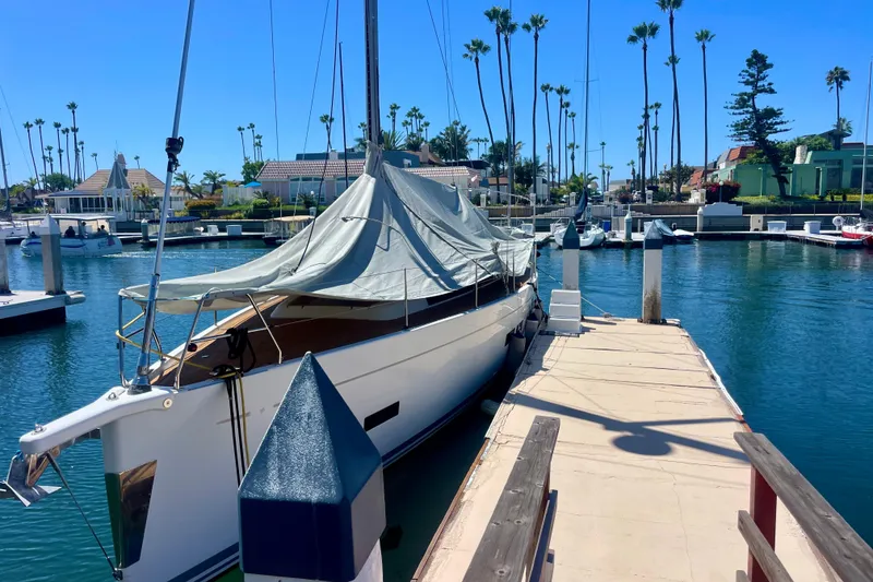 Slide: The Image of Grand Soleil 43F sailboat docked in a sunny marina, covered with a tarp. - 3