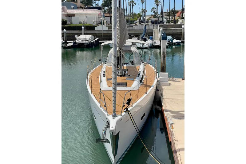 Slide: The Image of 2014 Grand Soleil 43F yacht docked in a marina, showcasing sleek design and wooden deck. - 34