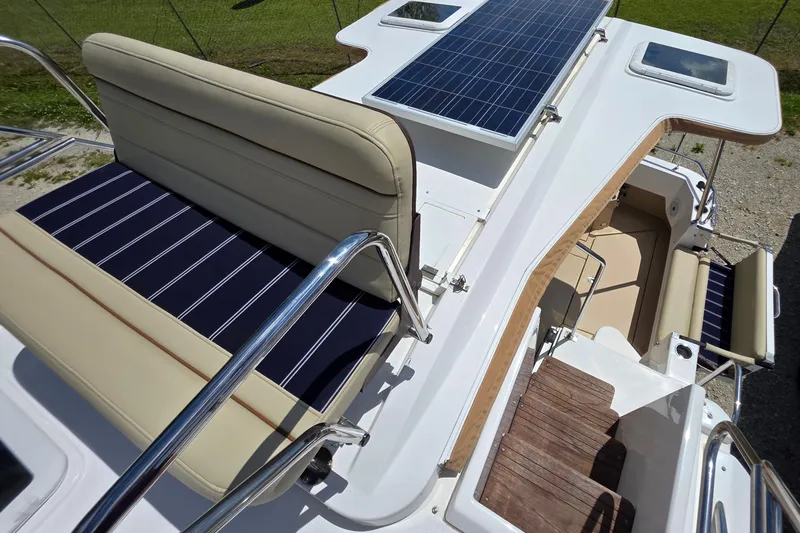 Slide: The Image of 2020 Ranger Tugs R-31 CB boat with solar panels and cushioned seating on deck. - 16