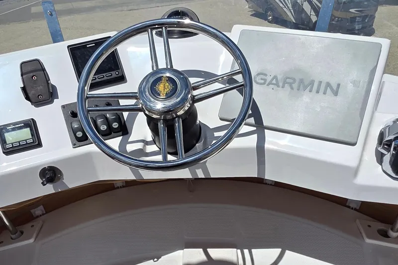 Slide: The Image of Helm of 2020 Ranger Tugs R-31 CB with Garmin navigation system and steering wheel. - 18