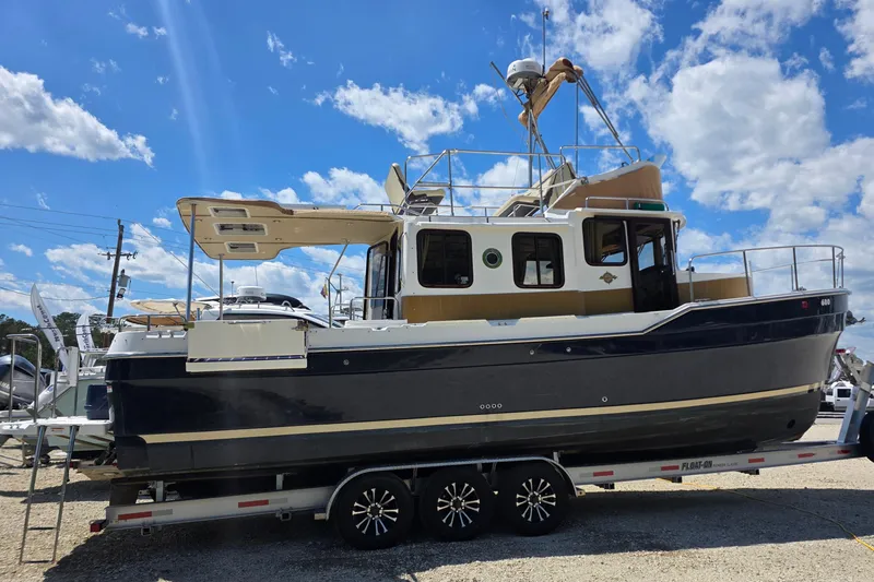 Slide: The Image of 2020 Ranger Tugs R-31 CB boat on trailer under a clear blue sky. - 2