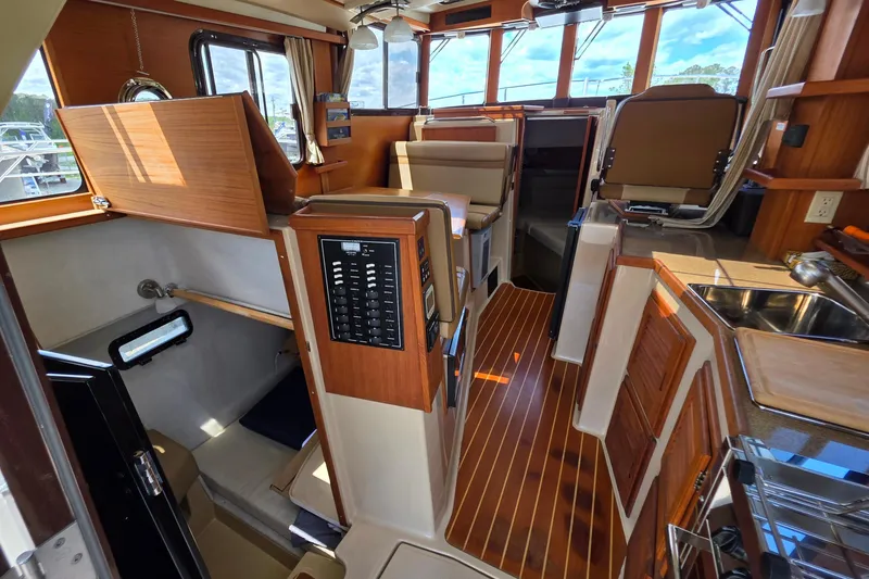 Slide: The Image of Interior of 2020 Ranger Tugs R-31 CB, featuring wood accents and modern amenities. - 20