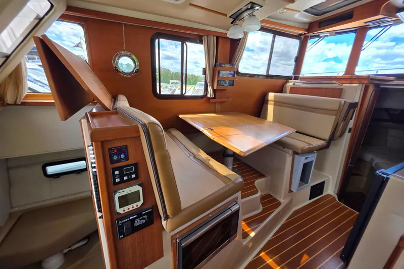 Slide: The Image of Interior of 2020 Ranger Tugs R-31 CB with wood accents and seating area. - 21