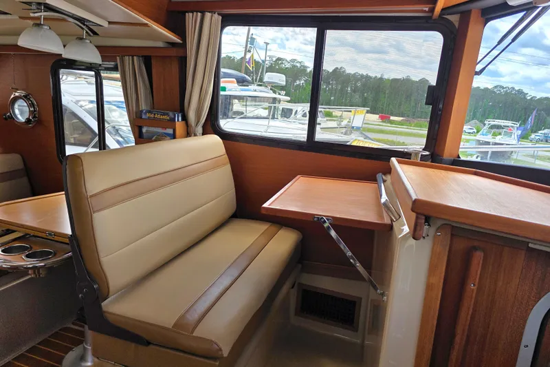 Slide: The Image of Interior of 2020 Ranger Tugs R-31 CB with seating and window view. - 22