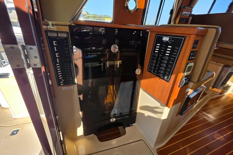 Slide: The Image of Interior view of 2020 Ranger Tugs R-31 CB boat with control panels and wood finish. - 27