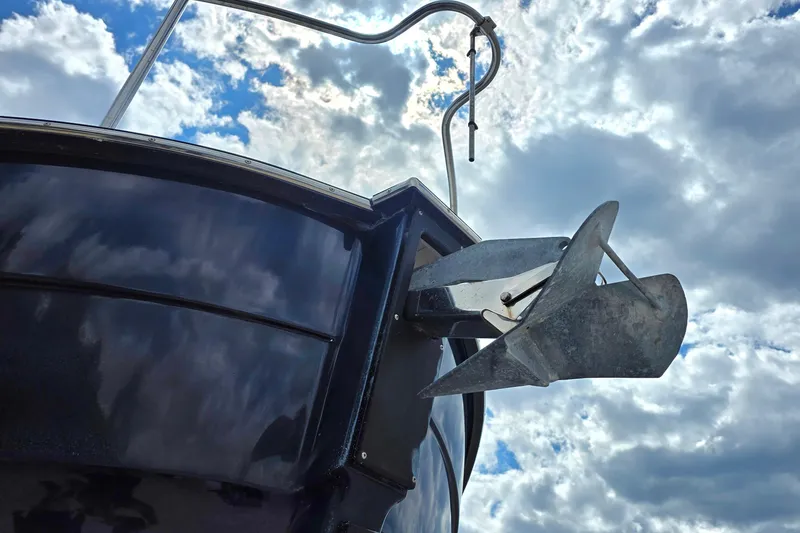 Slide: The Image of 2020 Ranger Tugs R-31 CB boat anchor against a cloudy sky backdrop. - 3