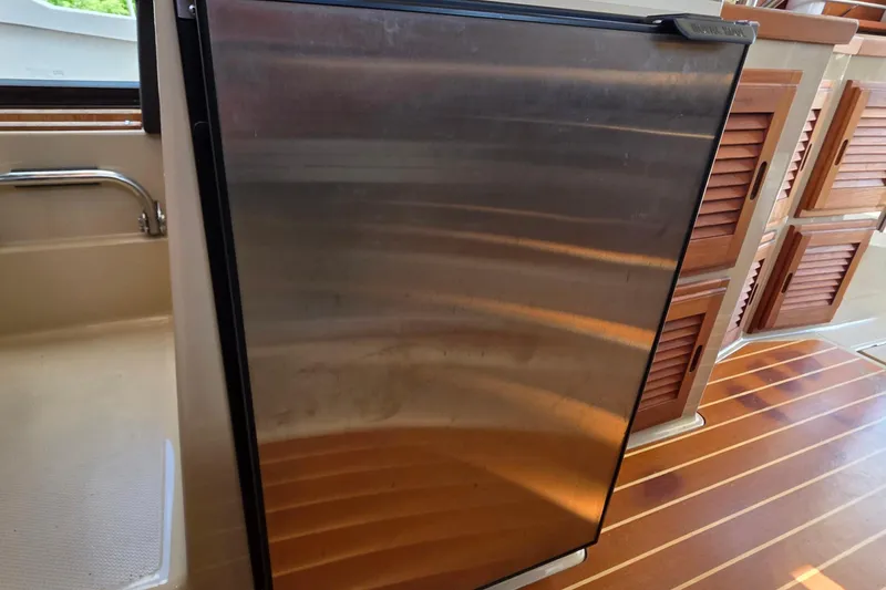 Slide: The Image of Stainless steel refrigerator on 2020 Ranger Tugs R-31 CB boat interior. - 31