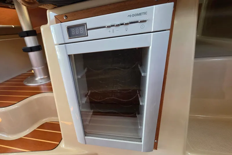 Slide: The Image of Compact Dometic fridge inside 2020 Ranger Tugs R-31 CB boat, featuring digital controls. - 32