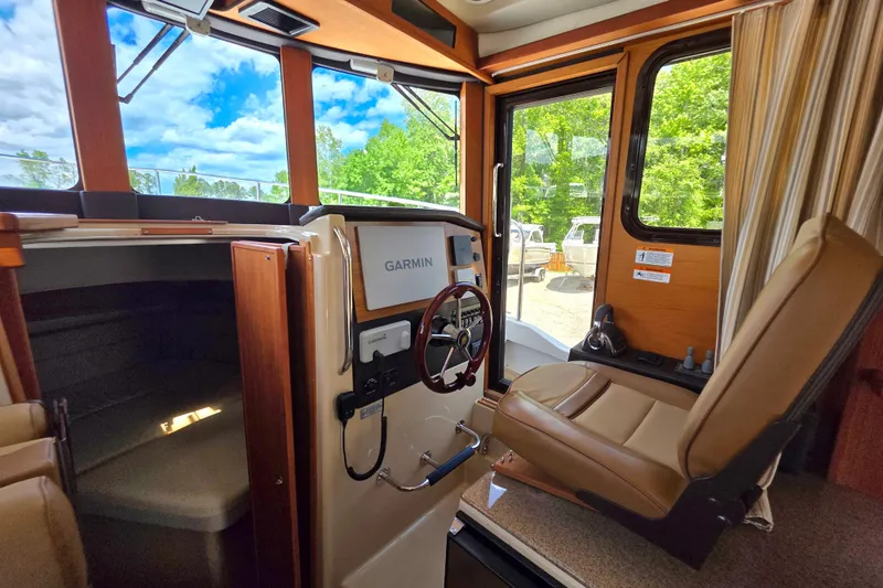Slide: The Image of Interior of 2020 Ranger Tugs R-31 CB with helm, Garmin display, and captain's chair. - 33