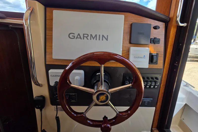 Slide: The Image of 2020 Ranger Tugs R-31 CB helm with Garmin navigation system and wooden steering wheel. - 34