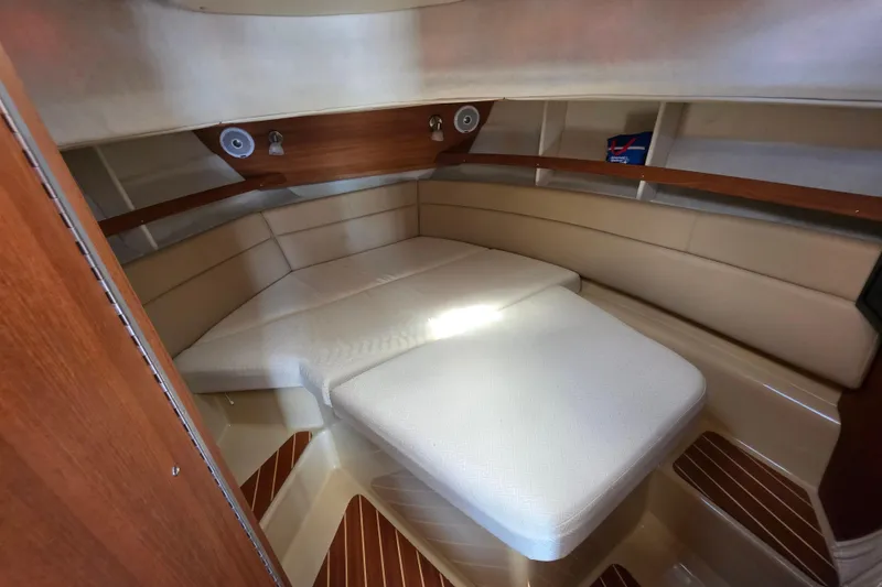 Slide: The Image of 2020 Ranger Tugs R-31 CB cabin interior with beige seating and wood accents. - 36
