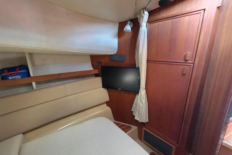 Slide: The Image of 2020 Ranger Tugs R-31 CB cabin interior with TV and wooden cabinetry. - 38