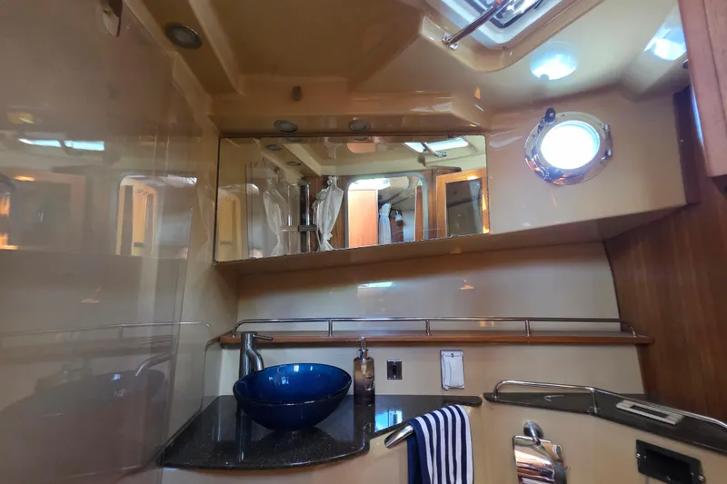 Slide: The Image of Luxurious bathroom interior of 2020 Ranger Tugs R-31 CB with modern fixtures and porthole. - 40